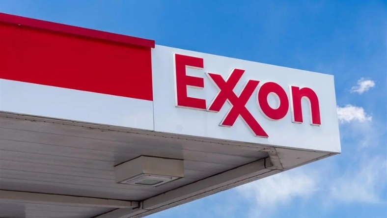 Exxon logo displayed at fuel station canopy against blue sky